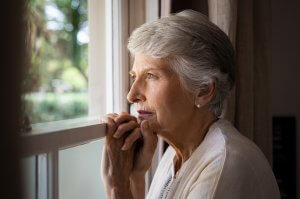 photo of a depressed senior woman at nursing home